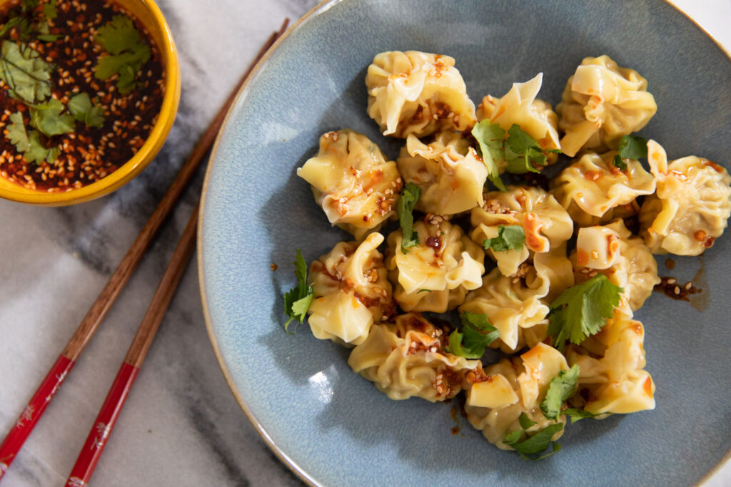 Chinese Pork & Prawn Wontons with Spicy Dipping Sauce closeup.