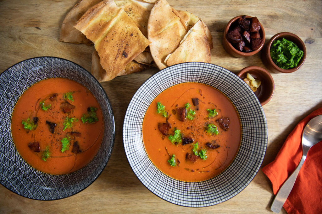 Roasted Red Pepper & Garlic Soup served with Persillade & Crispy Chorizo from above with toppings